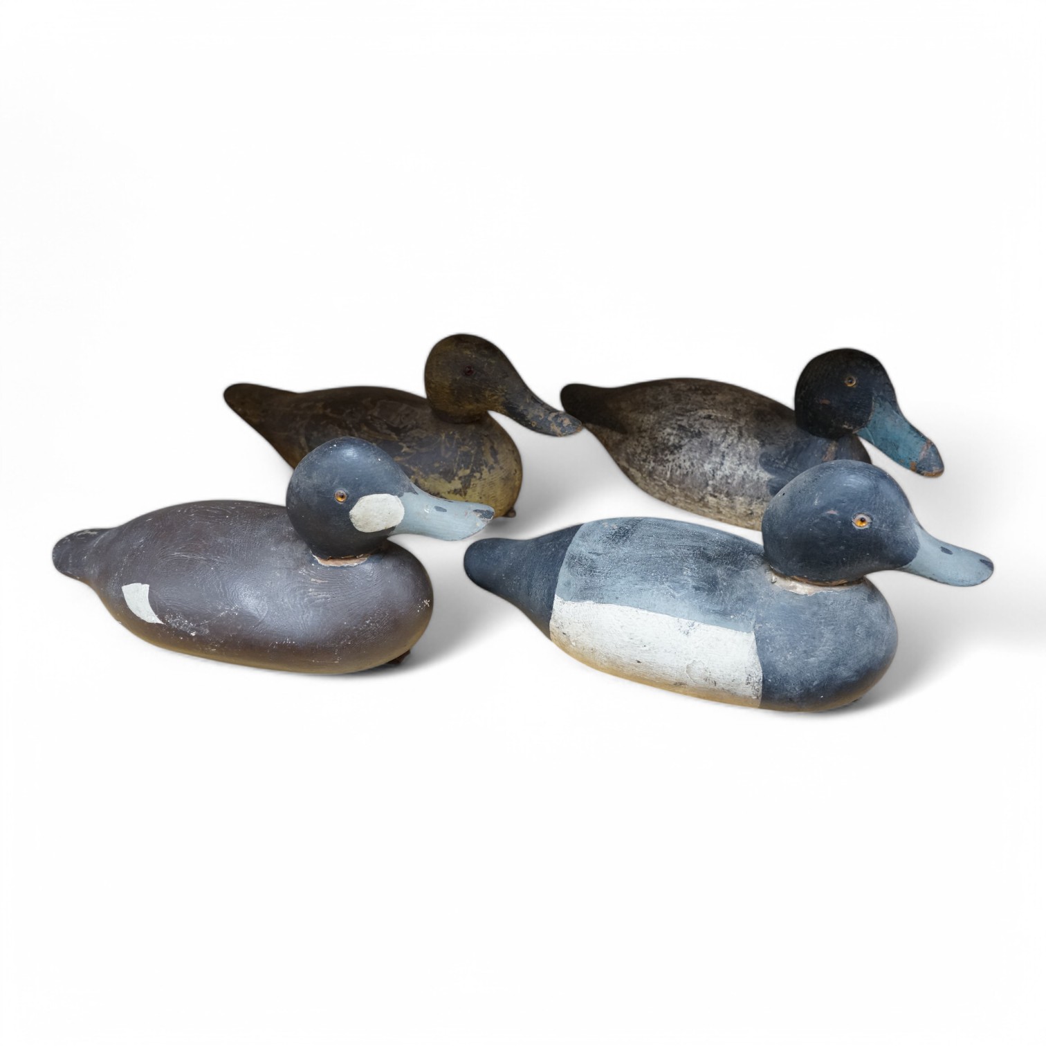 A group of four 19th and 20th century wooden decoy ducks, largest 39cm wide. Condition - fair